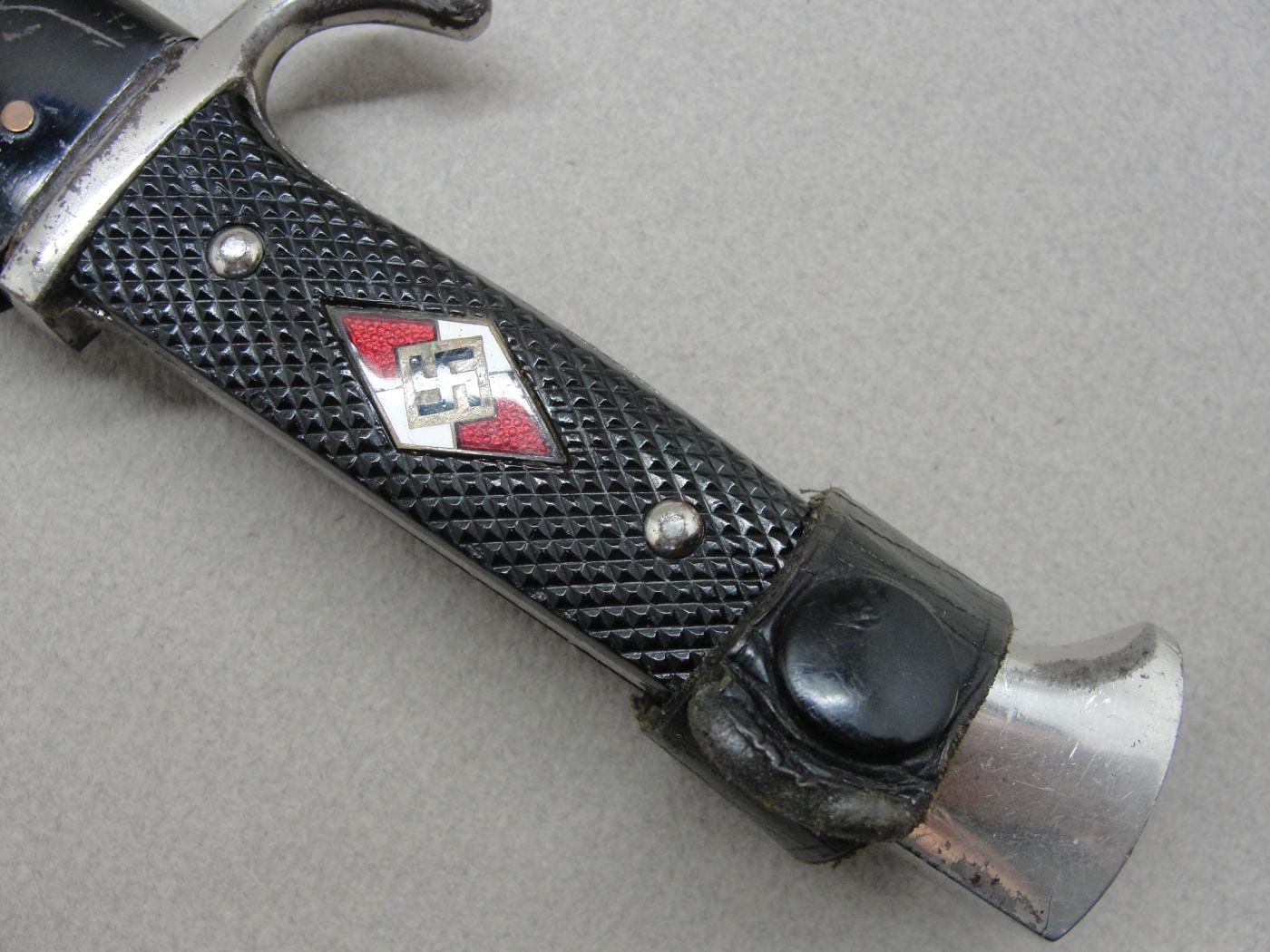 A dagger M 37 for Hitler Youth leaders, with hanger. Maker M7/36, E & F  Hörster, Solingen. Plated blade, the obverse side etched with the motto  Blut und Ehre! (Blood and Honour!).
